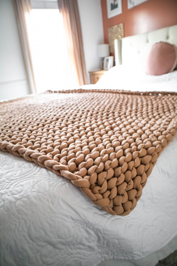 Bearaby Tree Napper Cooling Weighted Blanket laying across Nicki Odom's bed