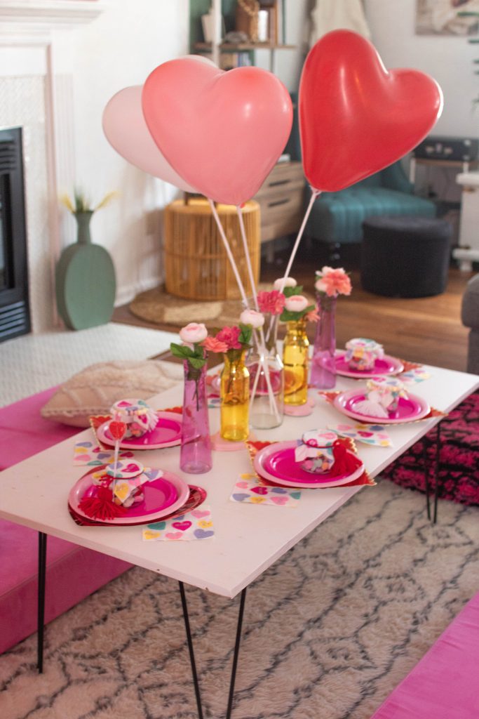 Little Girly Galentine's Day Party dining table decorations and balloon arch photo opt