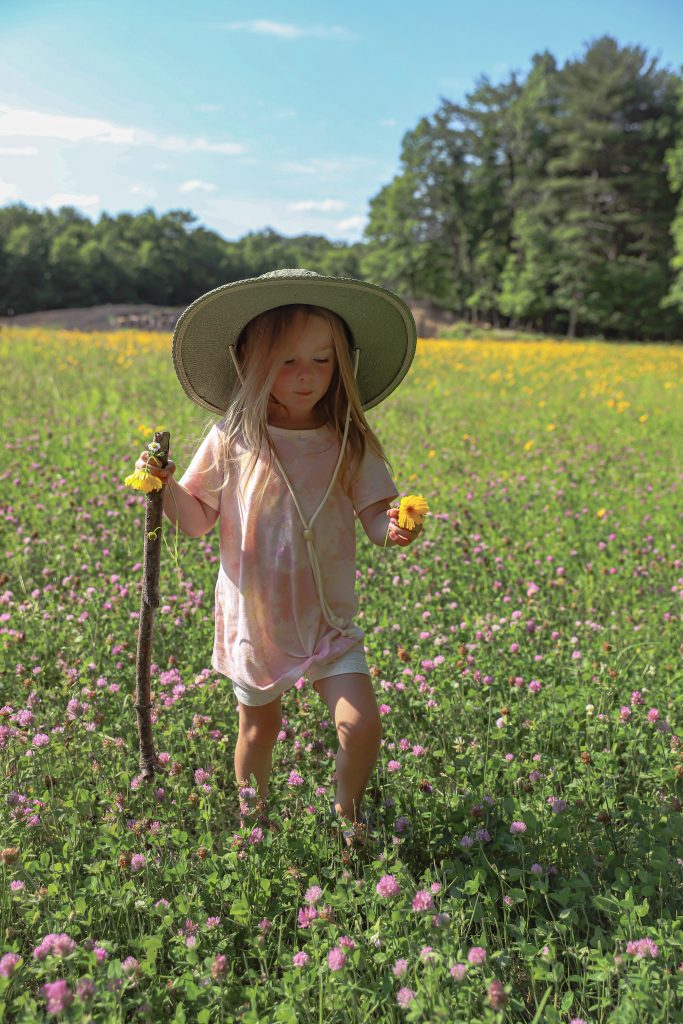 Nicki Odom's daughter picking flowers in wild flower field