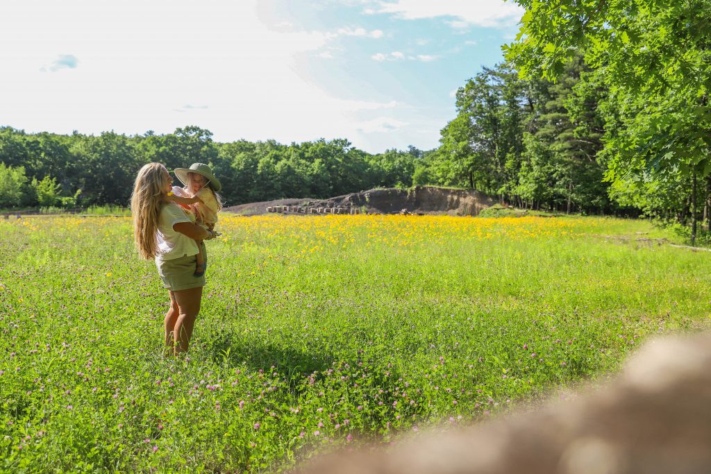 Nicki Odom's daughter picking flowers in wild flower field