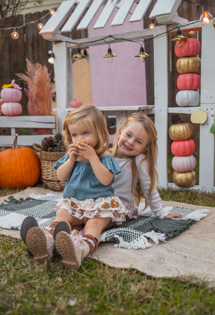 Nicki Odom's daughters in front of DIY Kids Market Pallet Wood project
