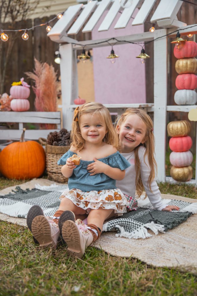 Nicki Odom's daughters in front of DIY Kids Market Pallet Wood Project