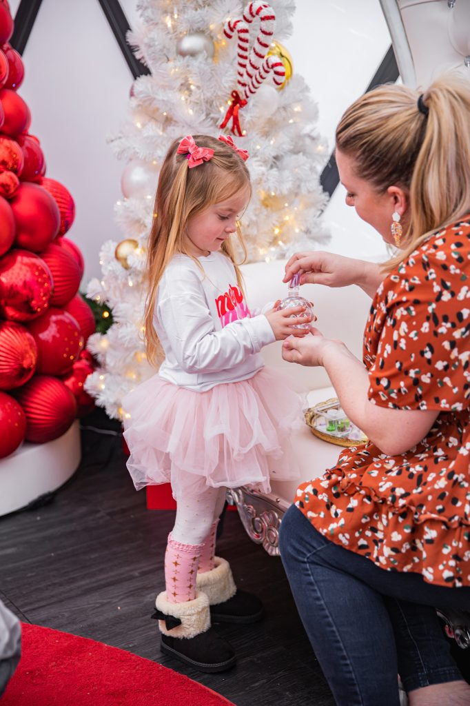 Nicki Odom with daughters make magic wands at Candy Cane Christmas tea party making a DIY ornament