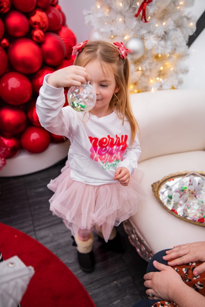 Nicki Odom with daughters make magic wands at Candy Cane Christmas tea party making a DIY ornament