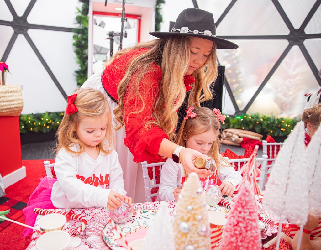 Nicki Odom with daughters make magic wands at Candy Cane Christmas tea party making a DIY ornament