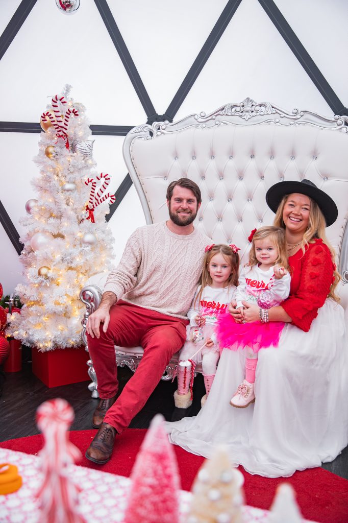 Nicki Odom and daughters visit with Santa in his igloo at Fenton, Cary NC