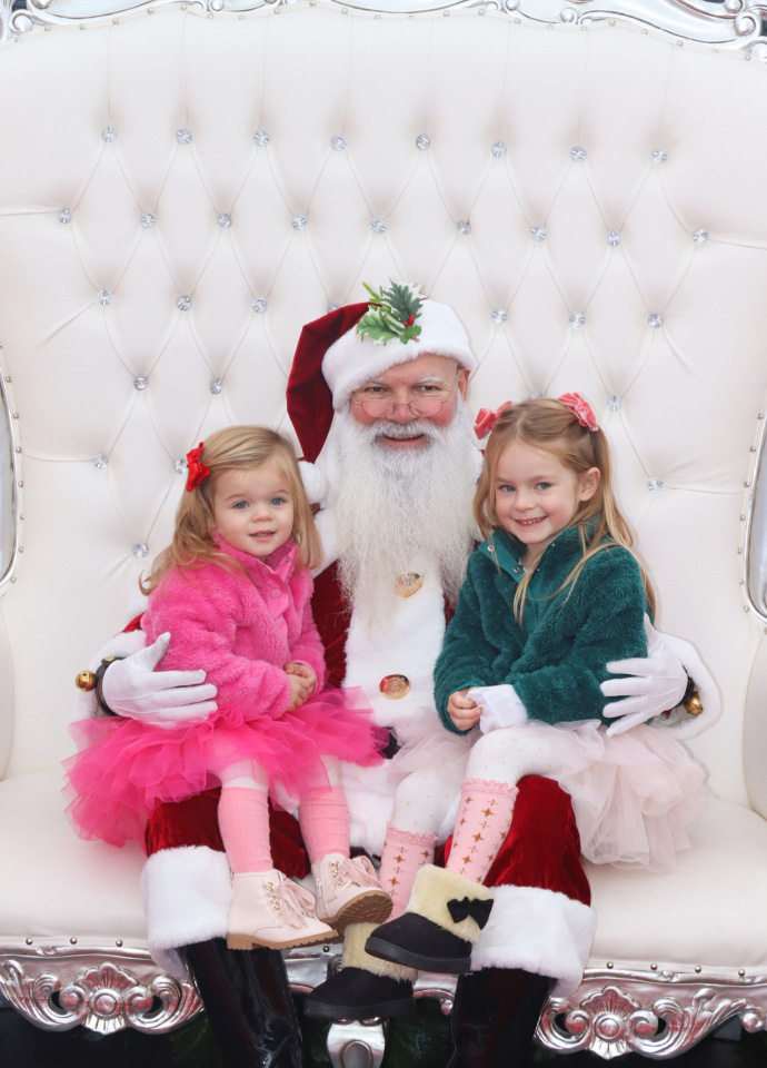 Nicki Odom and daughters visit with Santa in his igloo at Fenton, Cary NC