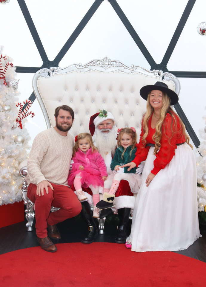 Nicki Odom and daughters visit with Santa in his igloo at Fenton, Cary NC