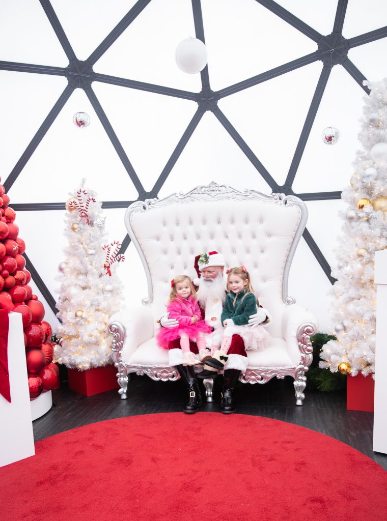 Nicki Odom and daughters visit with Santa in his igloo at Fenton, Cary NC