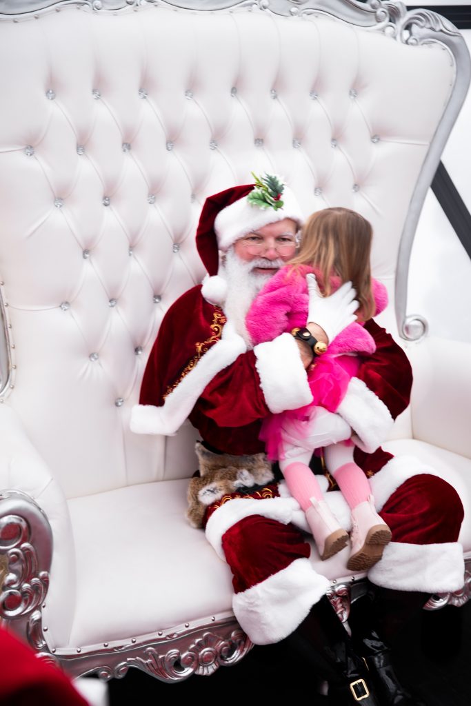 Nicki Odom and daughters visit with Santa in his igloo at Fenton, Cary NC