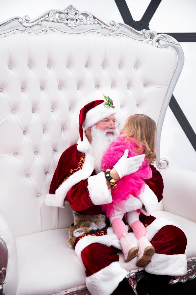 Nicki Odom and daughters visit with Santa in his igloo at Fenton, Cary NC