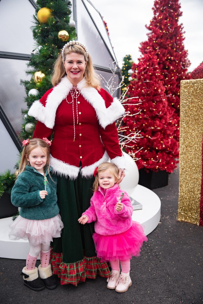 Nicki Odom and daughters visit with Santa and Mrs. Claus in an igloo at Fenton, Cary NC