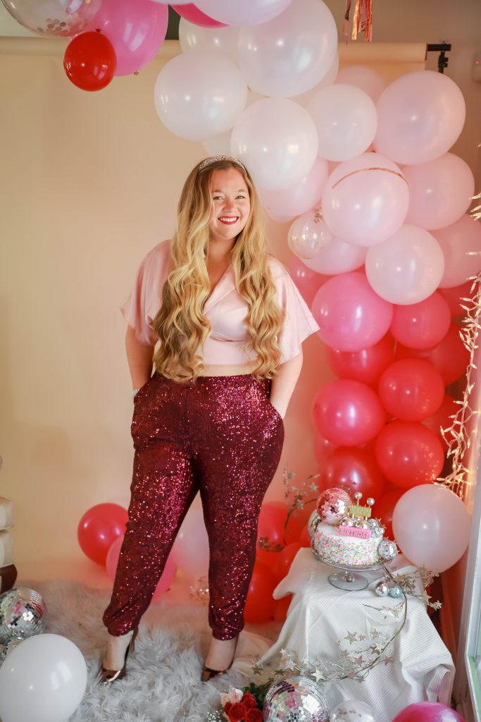 Birthday photoshoot with disco balls for Nicki Odom's 35th Birthday wearing plum sequin joggers and gold kimono