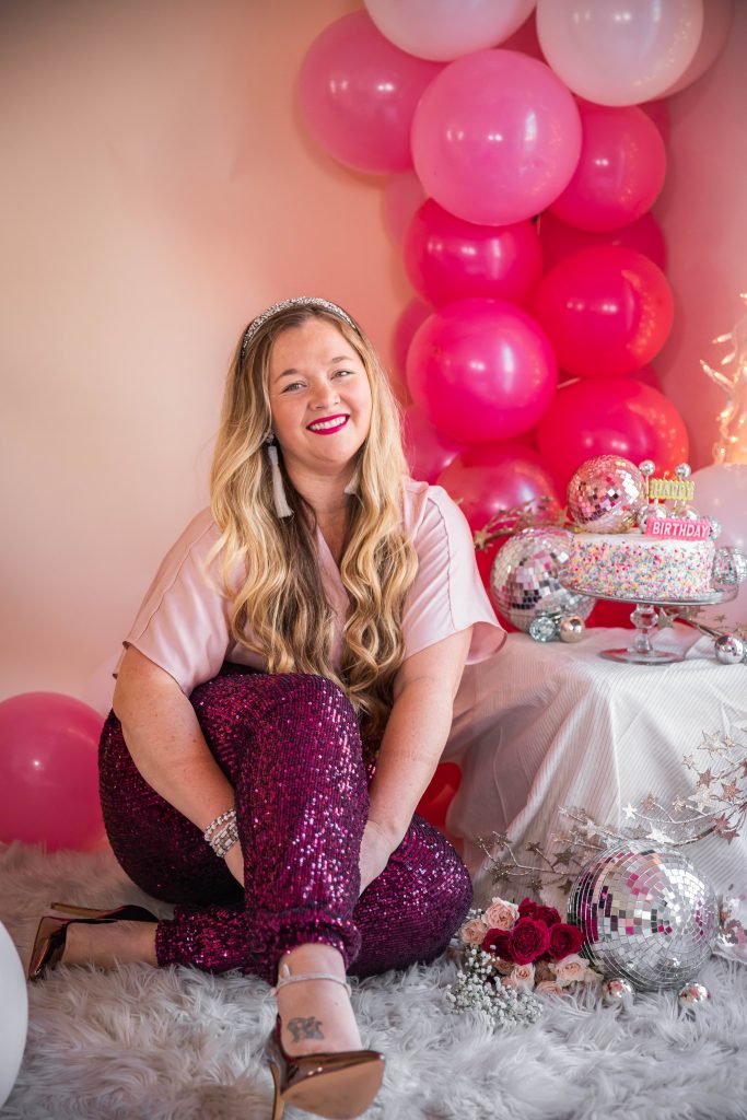 Birthday photoshoot with disco balls for Nicki Odom's 35th Birthday wearing plum sequin joggers and disco ball decorations How To Face Your Fears in 2023