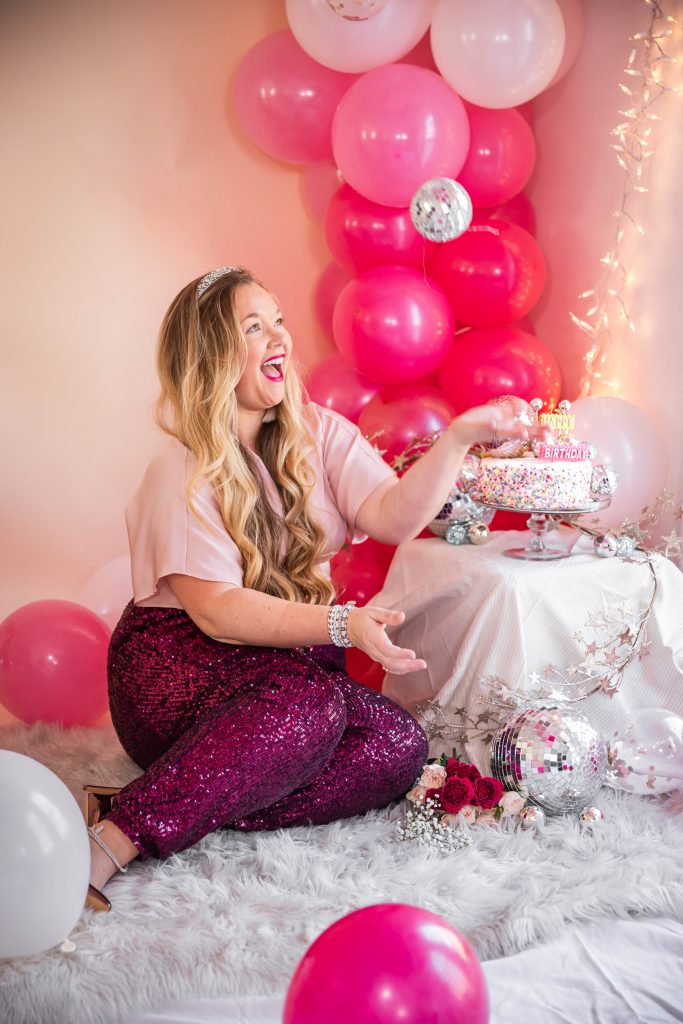 Birthday photoshoot with disco balls for Nicki Odom's 35th Birthday wearing plum sequin joggers and disco ball decorations How To Face Your Fears in 2023