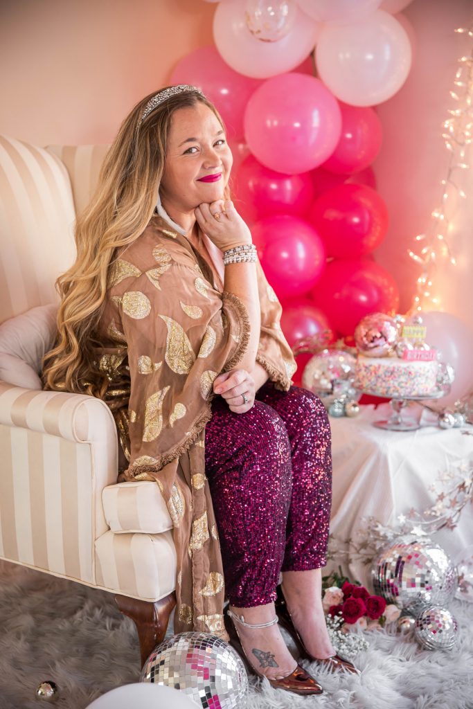 Birthday photoshoot with disco balls for Nicki Odom's 35th Birthday wearing plum sequin joggers and disco ball decorations How To Face Your Fears in 2023