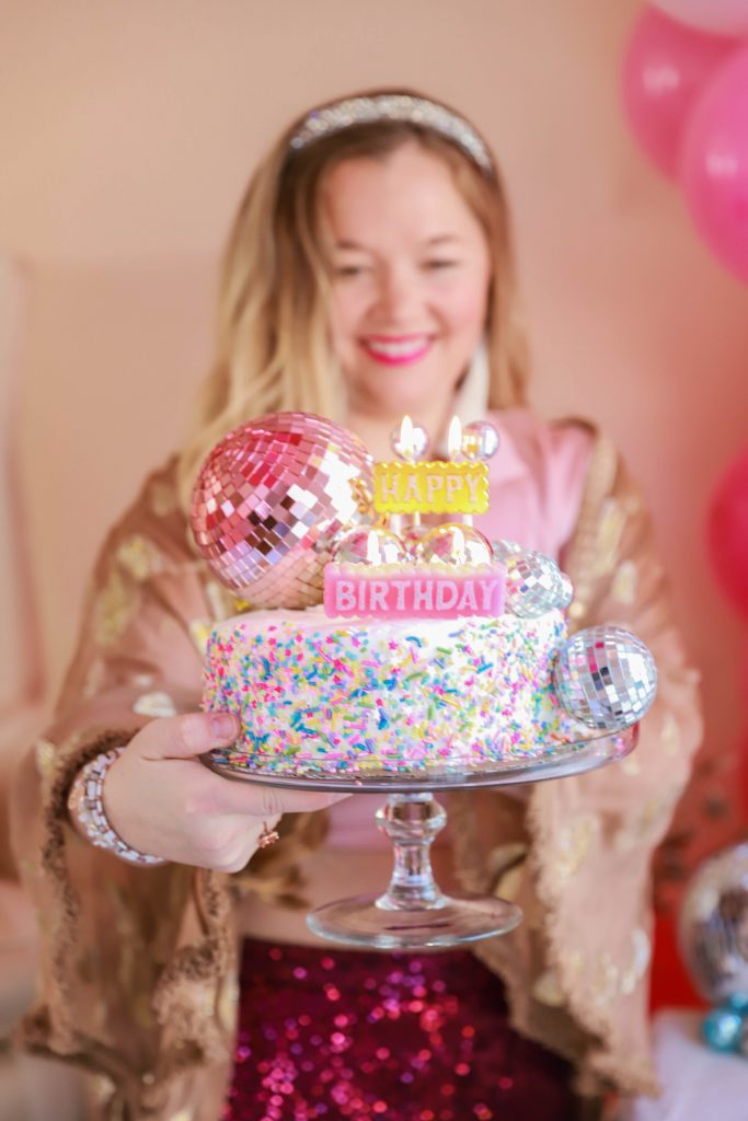 Birthday photoshoot with disco balls for Nicki Odom's 35th Birthday wearing plum sequin joggers and disco ball decorations How To Face Your Fears in 2023