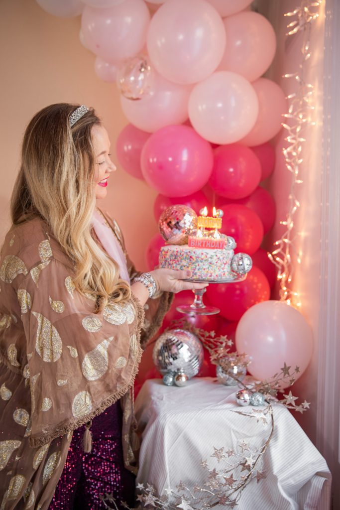 Birthday photoshoot with disco balls for Nicki Odom's 35th Birthday wearing plum sequin joggers and disco ball decorations How To Face Your Fears in 2023