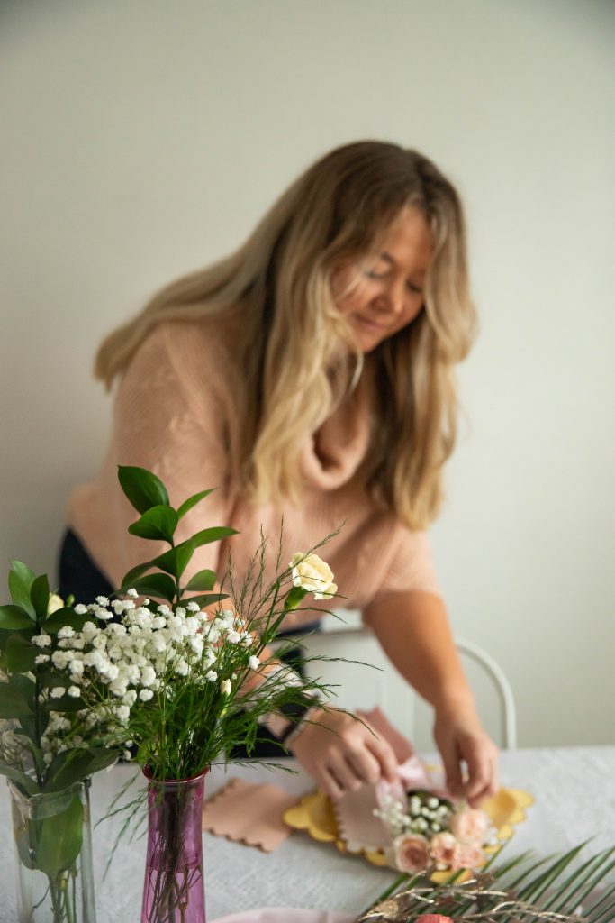 Nicki Odom setting the table to host a party