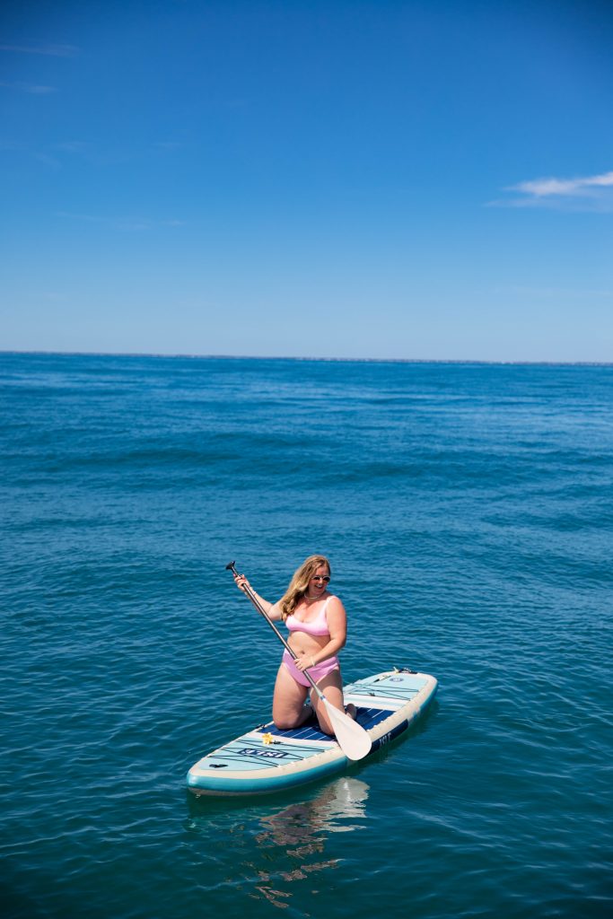 Nicki Odom on sailing catamaran catching a fish