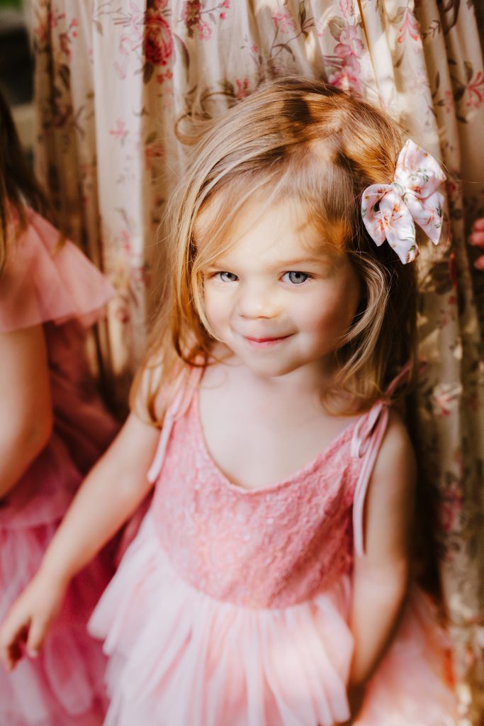 Nicki Odom's daughter in pink dress with blue eyes child portrait photography