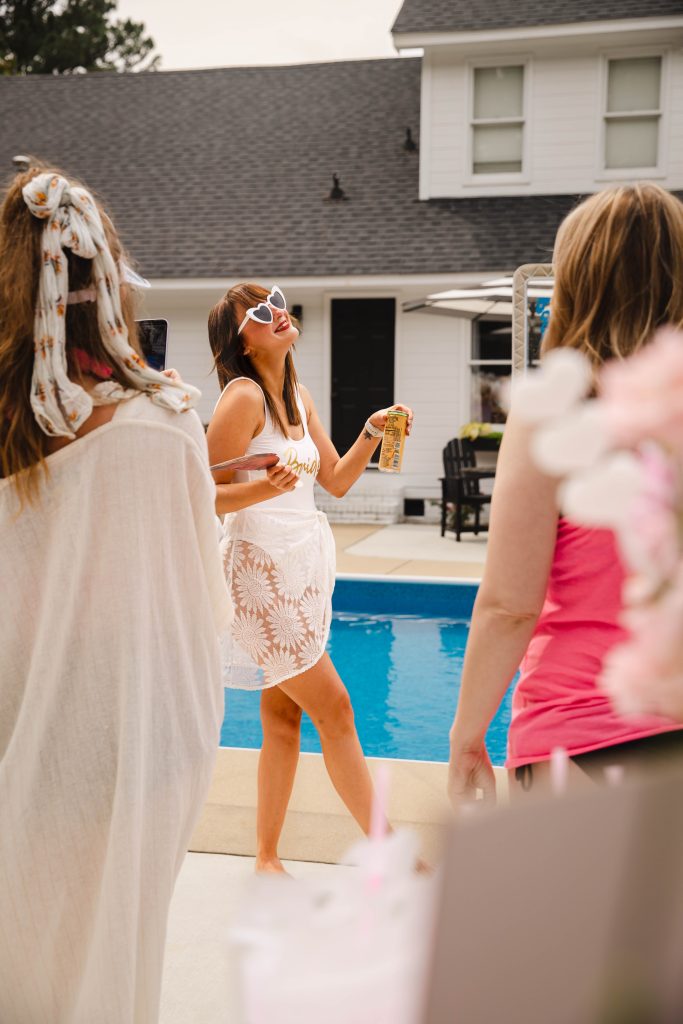 Bride To Be at her Bachelorette's Last Splash Pool Party drinking mimosa