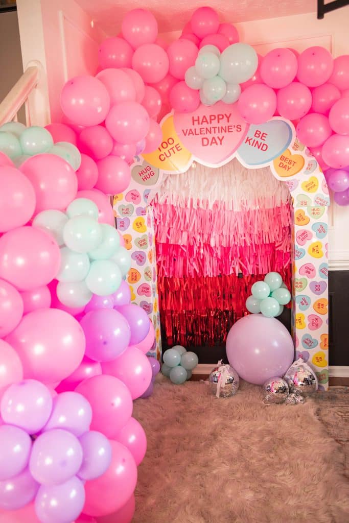 Conversation hearts photo back drop with balloon arch