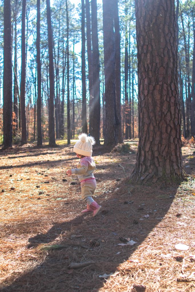 Toddler walking in the woods during winter