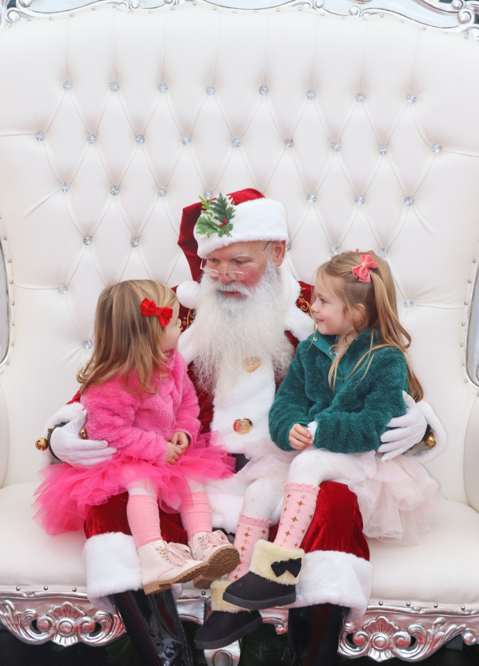 Nicki Odom and daughters visit with Santa in his igloo at Fenton, Cary NC