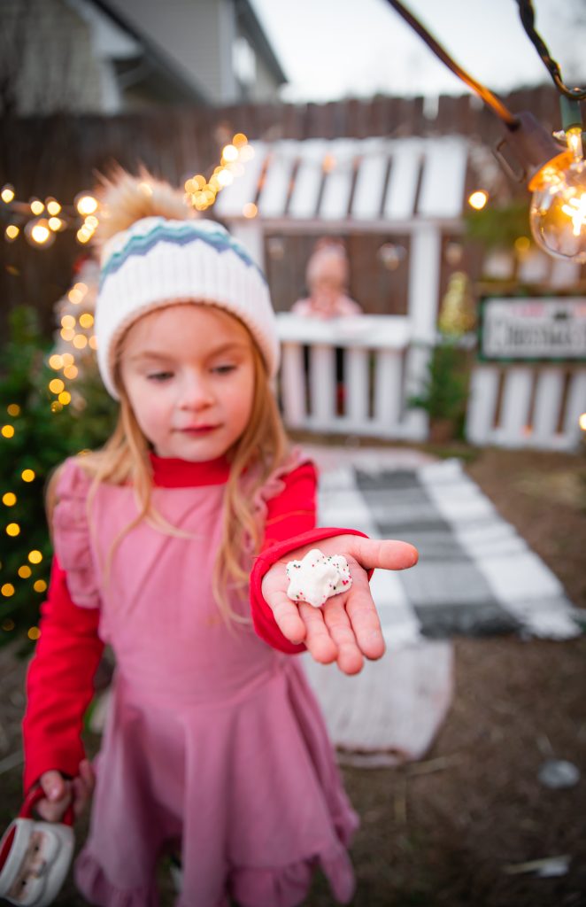 Kids Christmas Tree Farm Photoshoot - Nicki Odom's daughter holding a Christmas cookie
