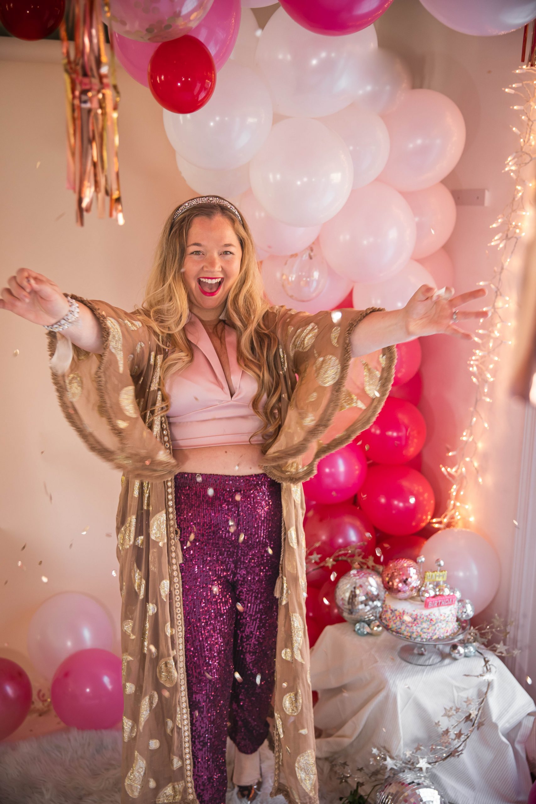 Birthday photoshoot with disco balls for Nicki Odom's 35th Birthday wearing plum sequin joggers and disco ball decorations How To Face Your Fears in 2023