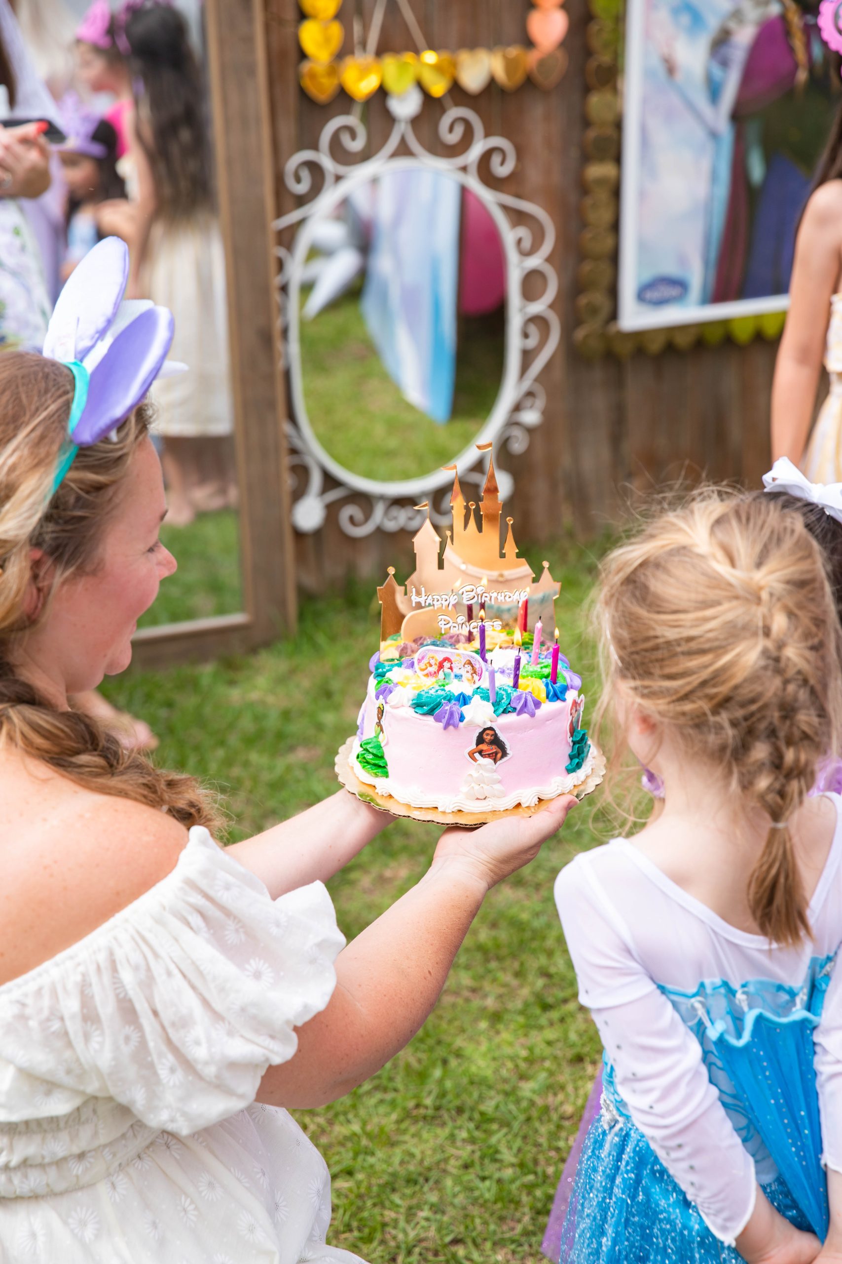 Disney Princess Birthday Party by Nicki Odom with her daughter and princess birthday cak