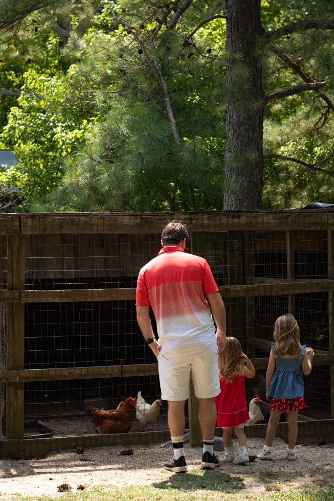 Nicki Odom and family feeding chickens at Gillis Hill Farm Fayetteville NC