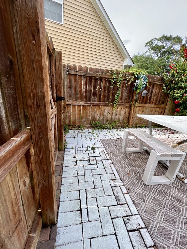 Back patio before the DIY transformation on wood privacy fence