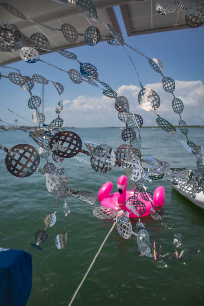 Boat Bachelorette Party with large Flamingo float in the water