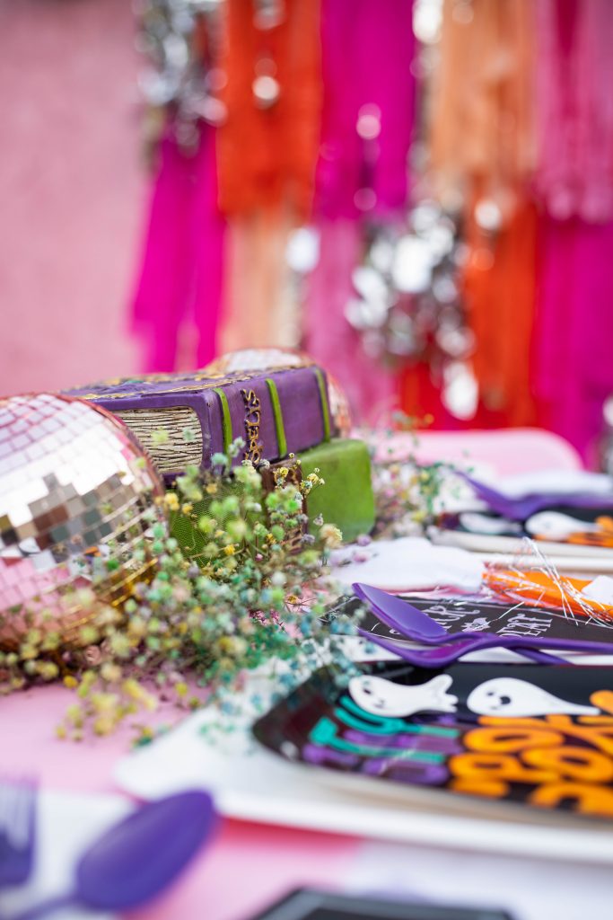 Ghoul Gang Girly Pink Halloween party with table setup and fringe background