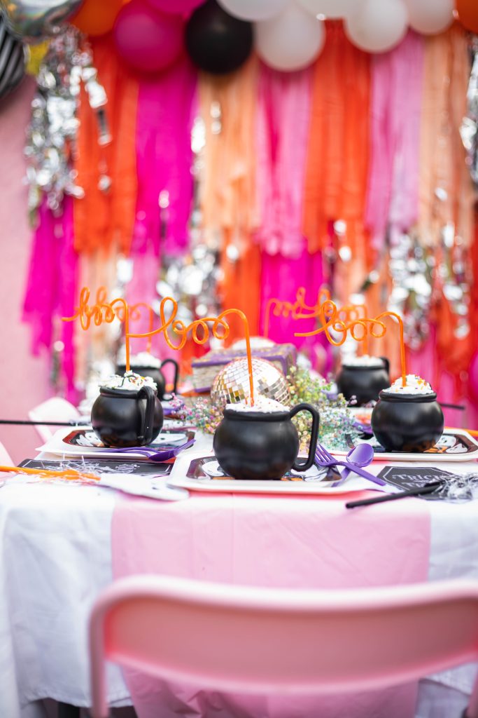 Halloween Party table decorations with pink fringe backdrop
