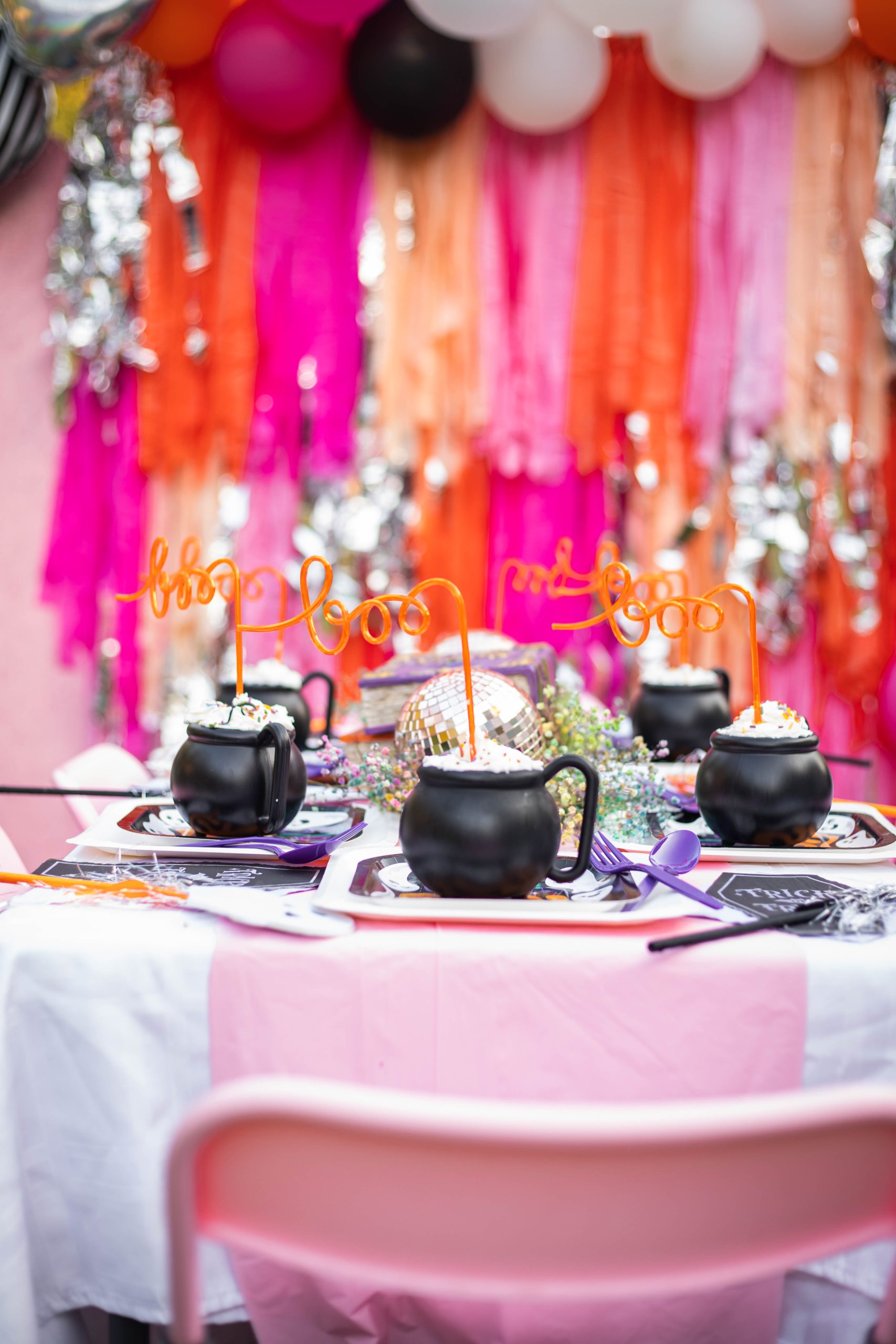 Halloween Party table decorations with pink fringe backdrop