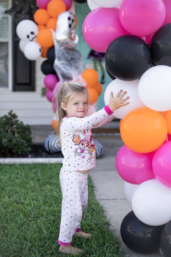 Nicki Odom's daughter helping with Halloween decorations