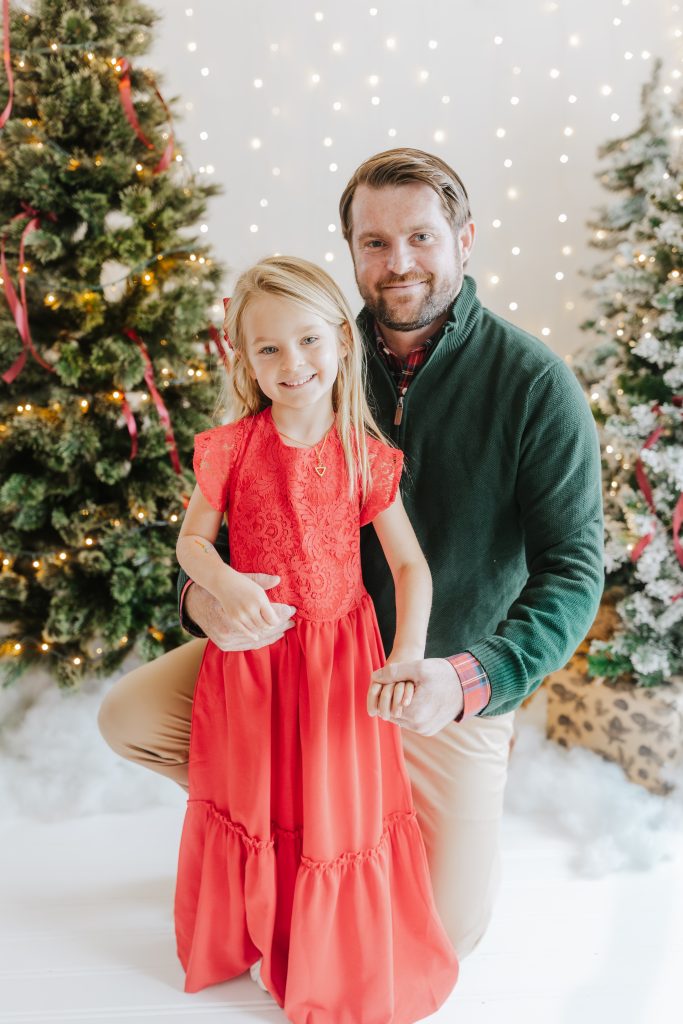 Morgan Odom with daughter beside Christmas Tree
