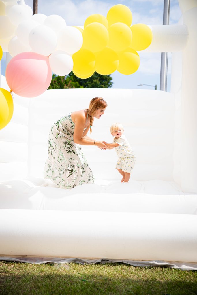 little boy in white bounce house