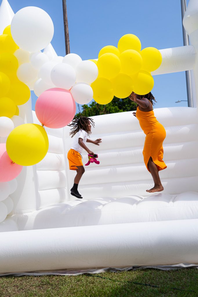 Squeeze the day party with white bounce house