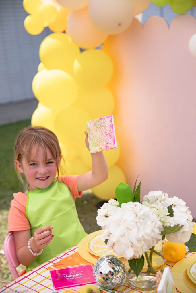 girl holding her canvas at Kids Citrus Art Summer Activity party