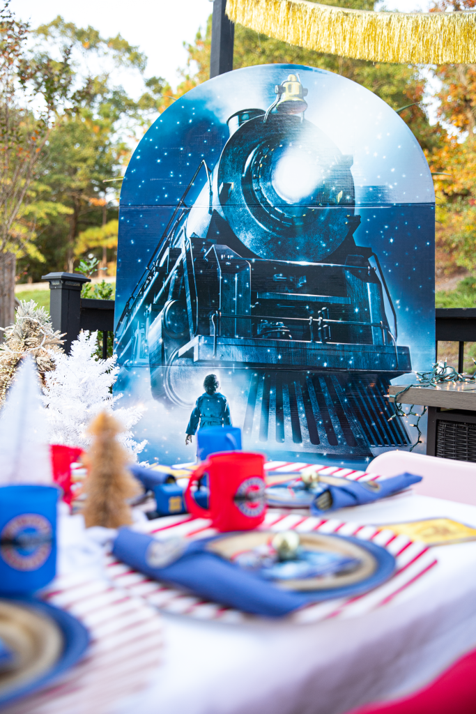 Party table and backdrop for kids Christmas Polar Express movie night